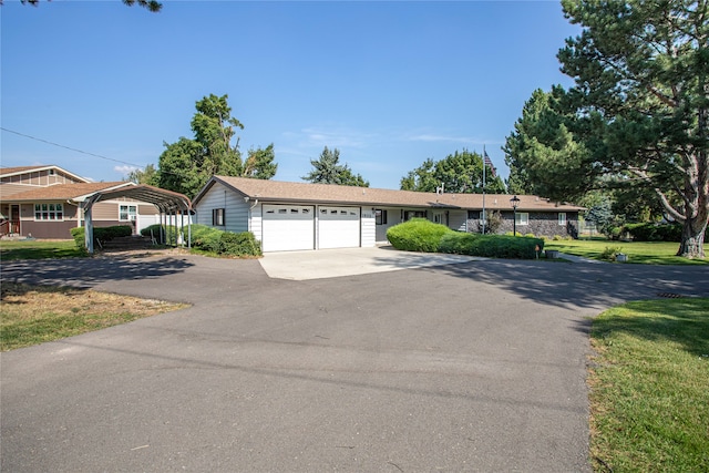 ranch-style house with a garage and a front yard