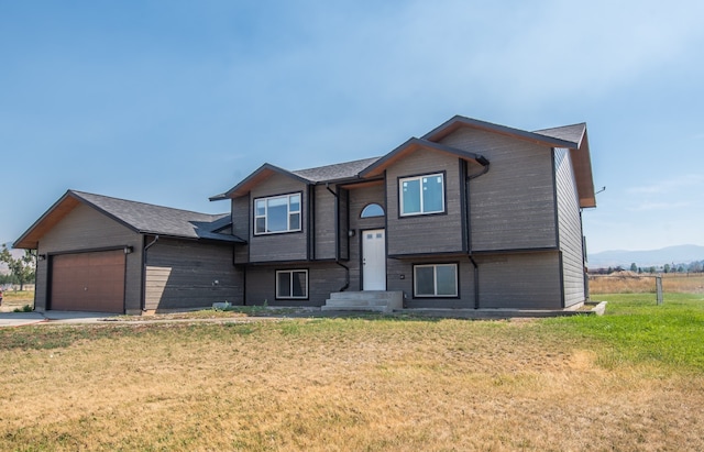 view of front of property with a front yard and a garage