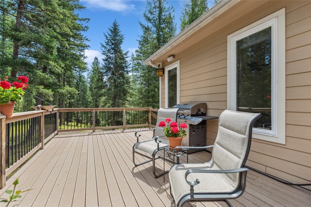 wooden deck featuring a grill