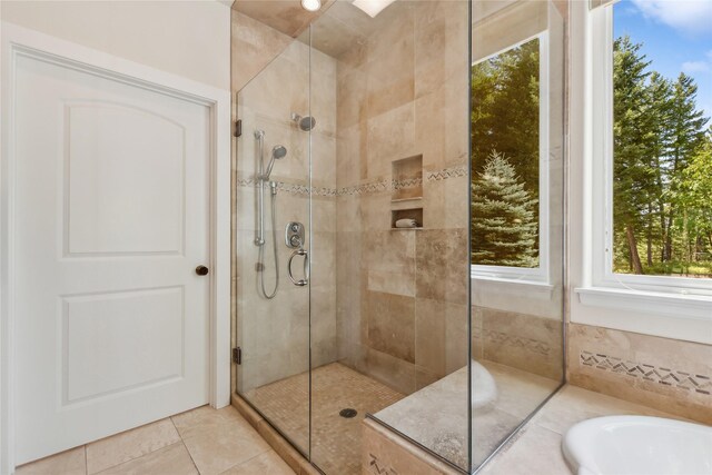 bathroom featuring tile patterned flooring and separate shower and tub