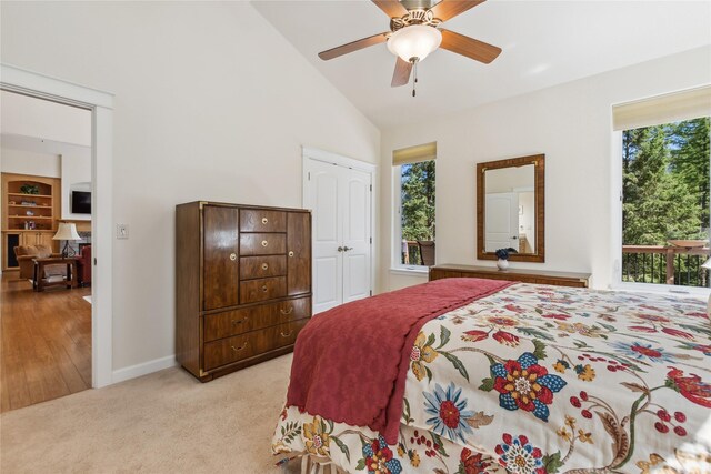 carpeted bedroom featuring high vaulted ceiling, multiple windows, and ceiling fan