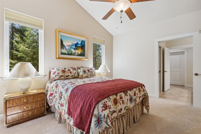 bedroom featuring multiple windows, ceiling fan, light tile patterned floors, and vaulted ceiling