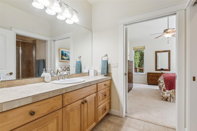 bathroom with tile patterned flooring, ceiling fan, and vanity