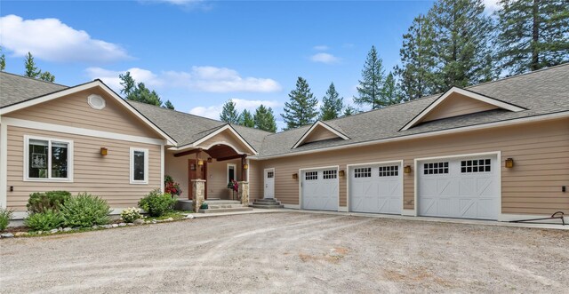 1550 Rolling Ridge Loop, Kalispell, MT 59901 - single story home featuring dirt driveway, a garage, and a shingled roof