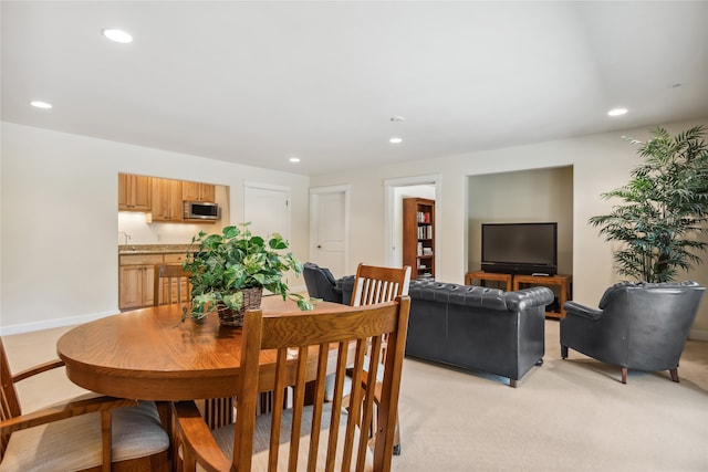 dining space with light colored carpet