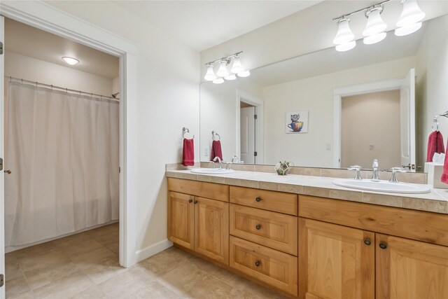 bathroom featuring tile patterned flooring and vanity