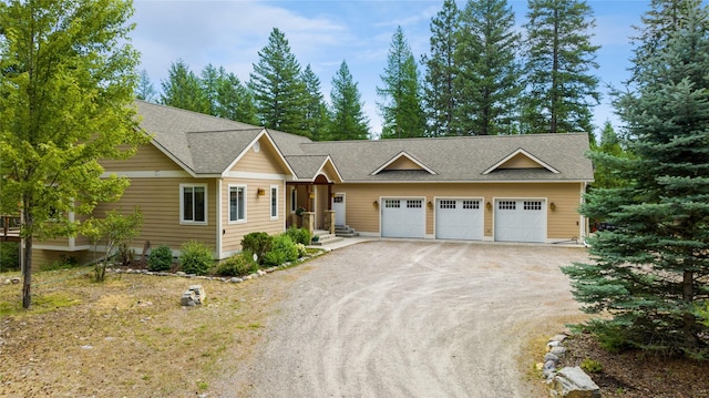 1550 Rolling Ridge Loop, Kalispell, MT 59901 - ranch-style home featuring dirt driveway, roof with shingles, and an attached garage