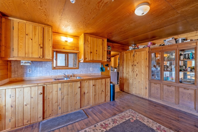 kitchen with dark hardwood / wood-style floors, wood ceiling, sink, and wooden walls