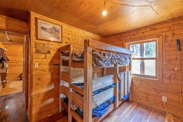 bedroom featuring wood walls, wooden ceiling, and hardwood / wood-style flooring