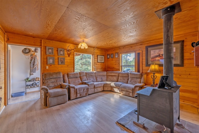 living room with light hardwood / wood-style flooring, a wealth of natural light, and wood ceiling