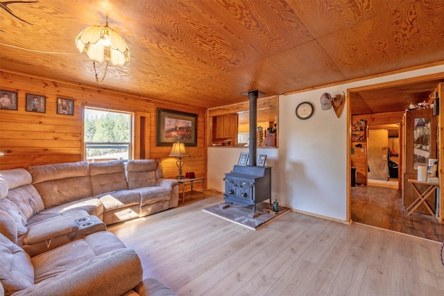4636 N Fork Rd, Cascade, MT 59421 - living room featuring a wood stove, light wood-type flooring, wooden walls, and wood ceiling