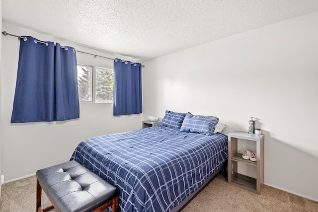 carpeted bedroom with baseboards and a textured ceiling