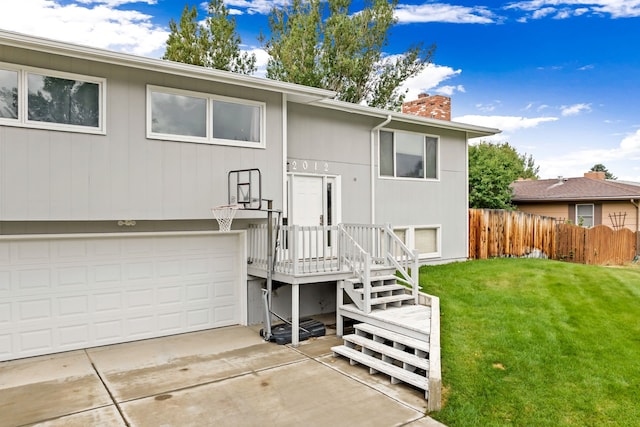 view of front of home with a garage, fence, driveway, a front lawn, and a chimney