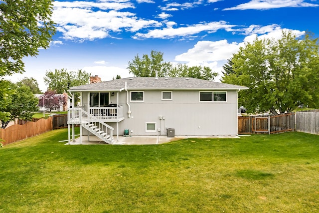 rear view of property with a fenced backyard, a chimney, a patio, and a yard