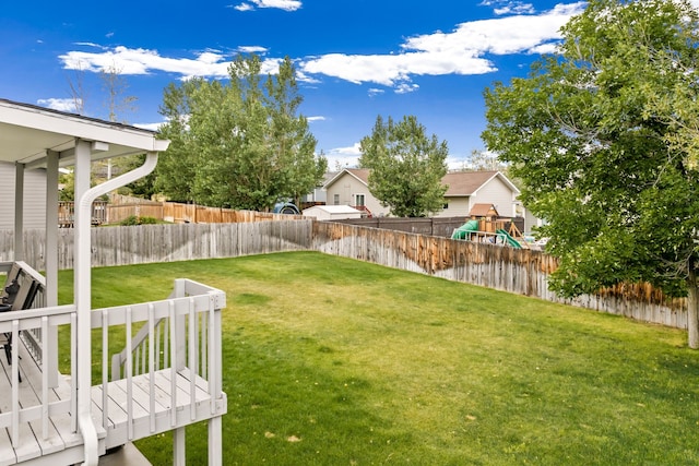 view of yard with fence and a playground