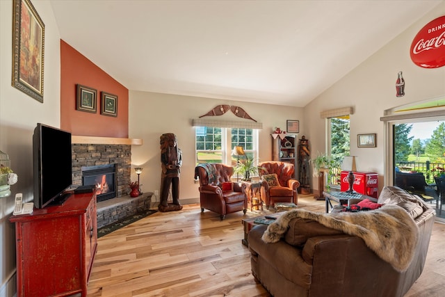 living room with a fireplace, high vaulted ceiling, and wood-type flooring