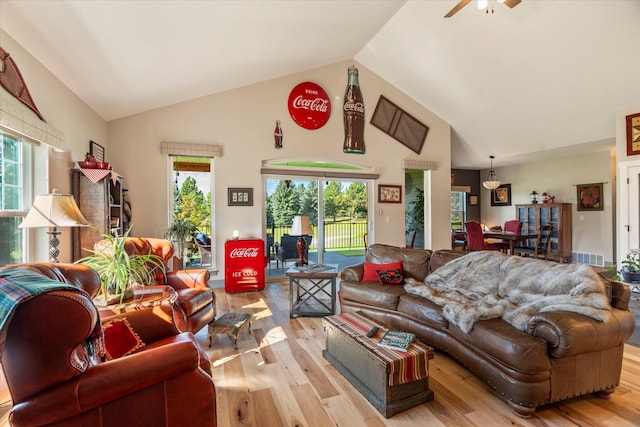 living room with high vaulted ceiling, ceiling fan, and light hardwood / wood-style floors