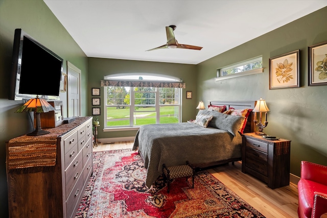 bedroom with light wood-type flooring, multiple windows, and ceiling fan