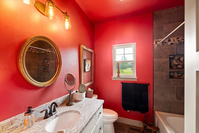 full bathroom featuring vanity, toilet, and tiled shower / bath