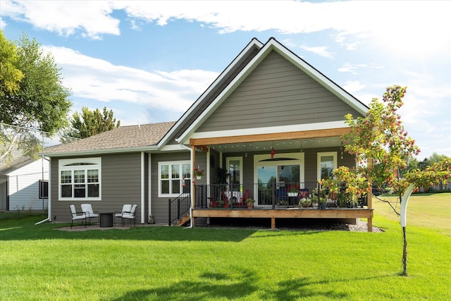 rear view of property with a yard