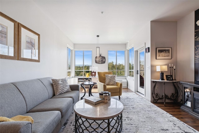 living room featuring dark wood-style flooring and baseboards