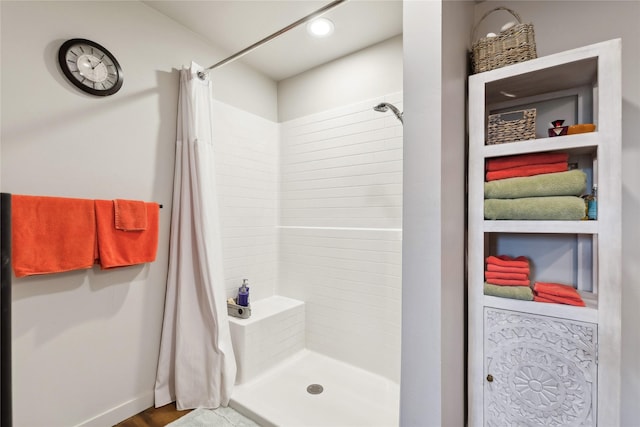 bathroom with a shower stall and recessed lighting