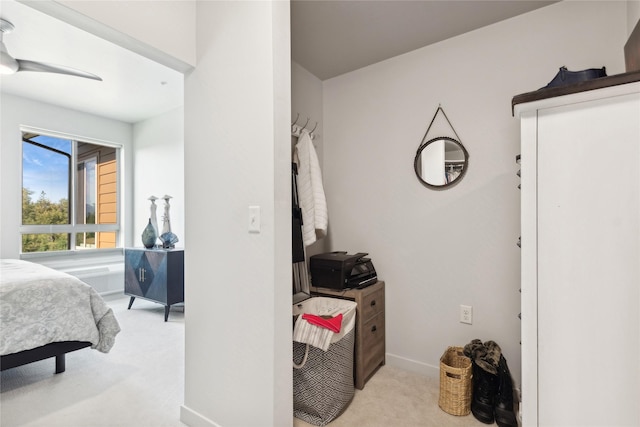 bedroom featuring baseboards and light colored carpet