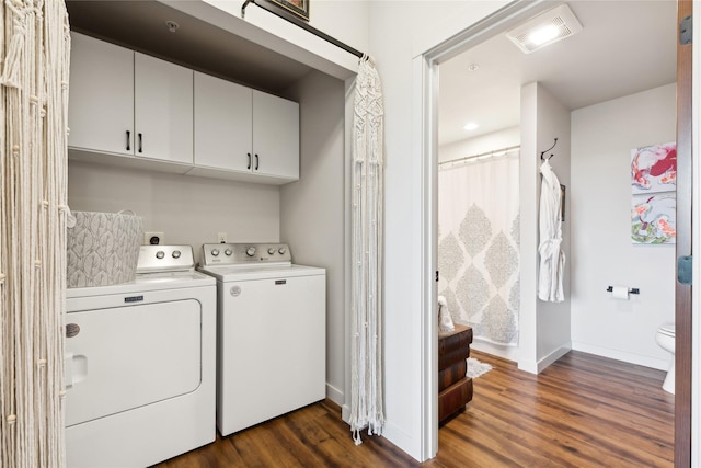 washroom featuring independent washer and dryer, dark wood-style flooring, cabinet space, and visible vents