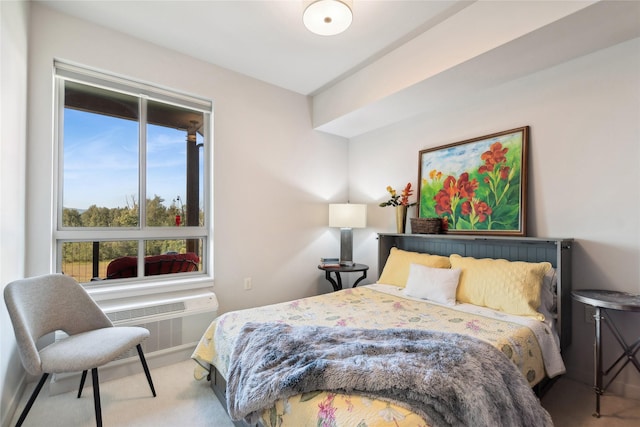 bedroom featuring carpet and a wall mounted air conditioner