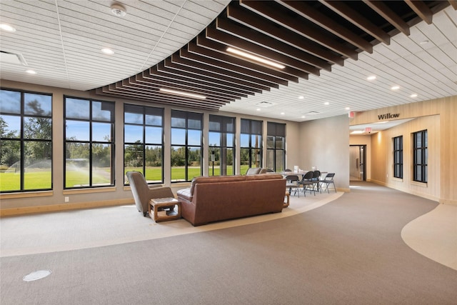 living room with baseboards, carpet, wood ceiling, and recessed lighting