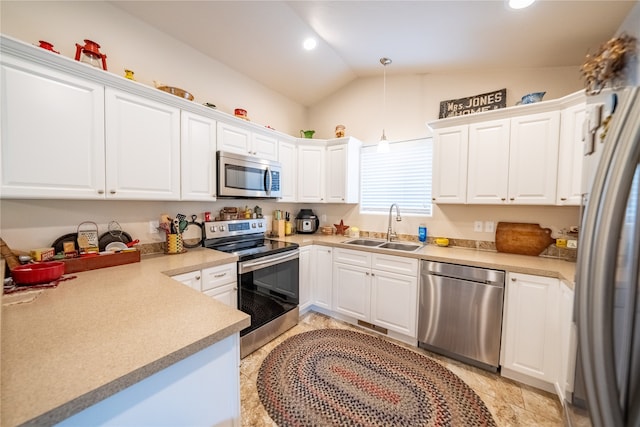 kitchen featuring decorative light fixtures, stainless steel appliances, sink, lofted ceiling, and light tile patterned flooring