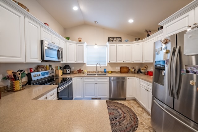 kitchen featuring light tile patterned floors, stainless steel appliances, white cabinetry, sink, and lofted ceiling