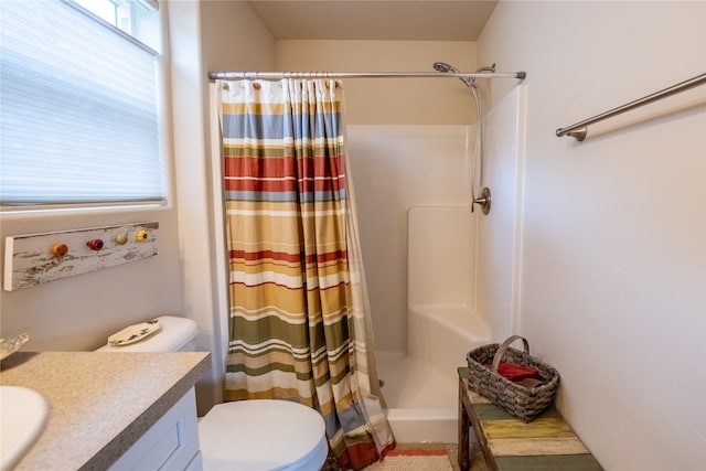 bathroom featuring vanity, toilet, and curtained shower