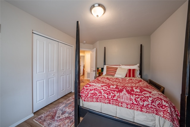 bedroom with a closet and hardwood / wood-style floors