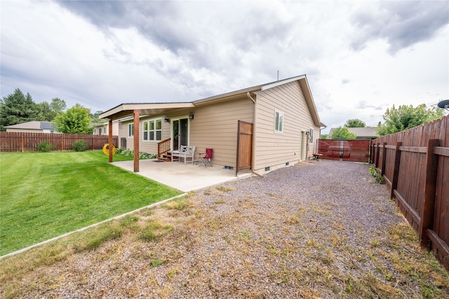 back of property featuring a patio area and a lawn