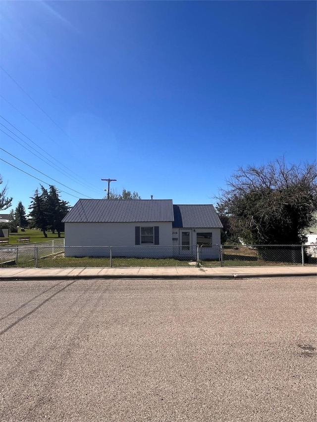 view of front of house with a fenced front yard and metal roof