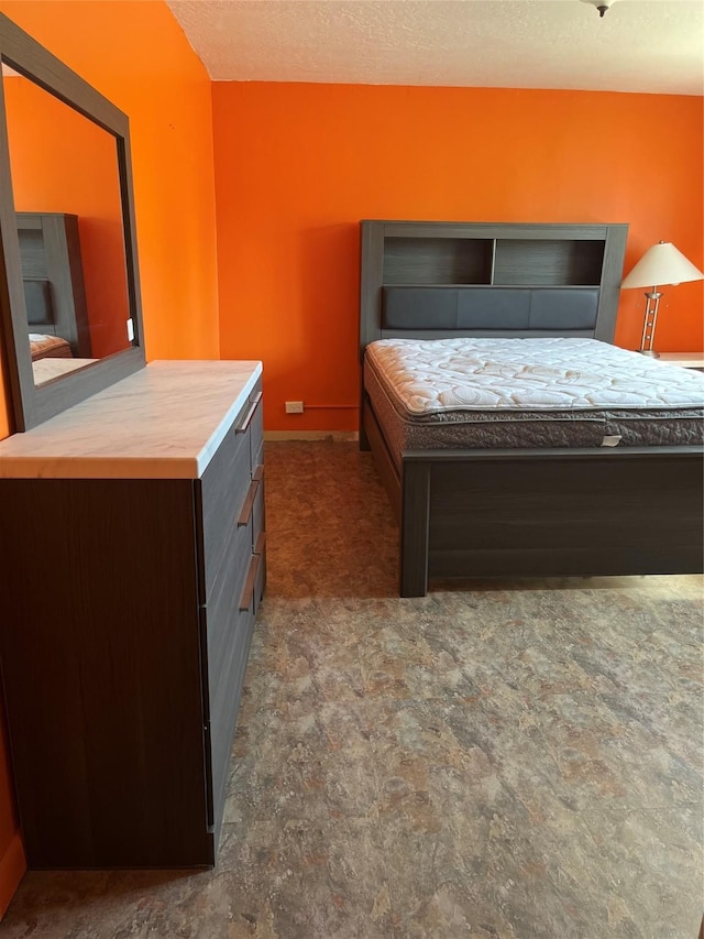 bedroom featuring carpet and a textured ceiling