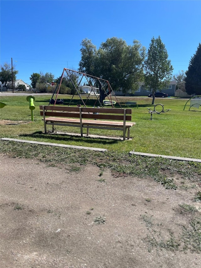 view of property's community with playground community and a lawn