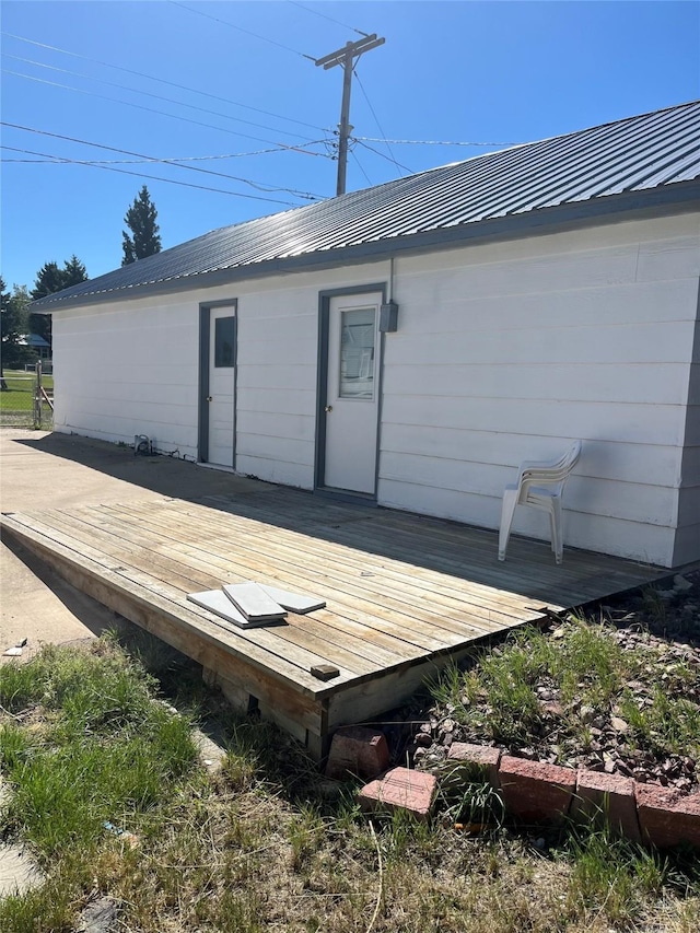 exterior space with a deck and metal roof