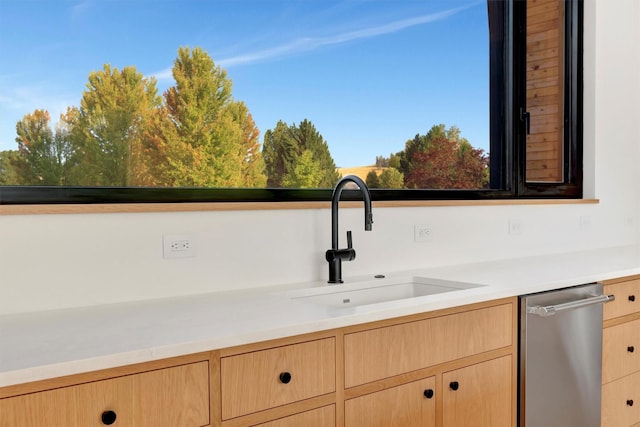 interior space featuring dishwasher, light brown cabinets, and sink