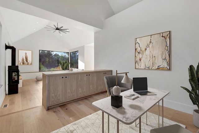 2025 Edward Ct, Missoula, MT 59804 - office with light wood-type flooring, a wood stove, high vaulted ceiling, and ceiling fan