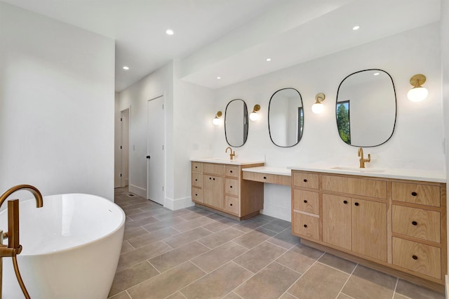 bathroom featuring tile patterned flooring, a bathtub, and vanity