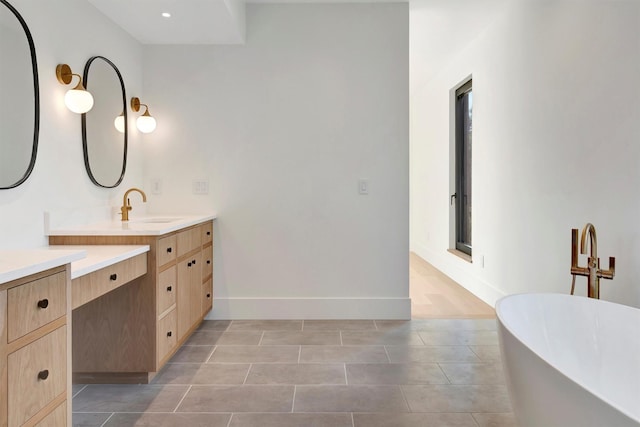 bathroom with tile patterned flooring, vanity, and a bathing tub