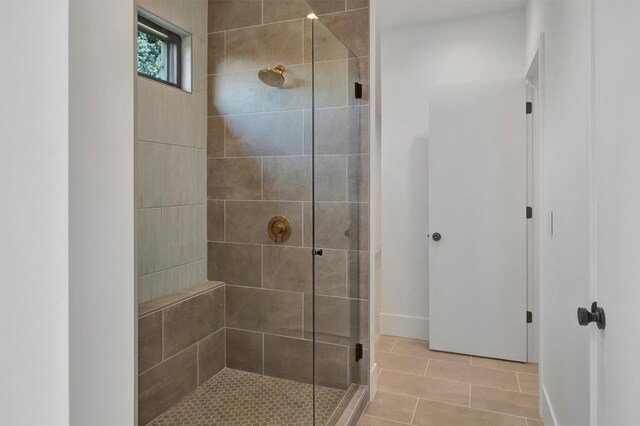 bathroom with tile patterned floors and walk in shower