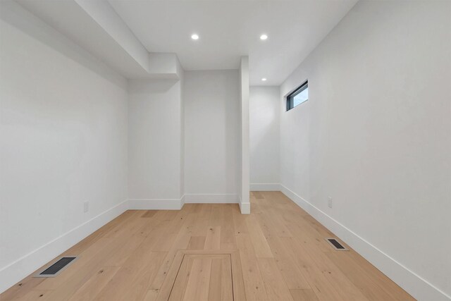 unfurnished room with light wood-type flooring