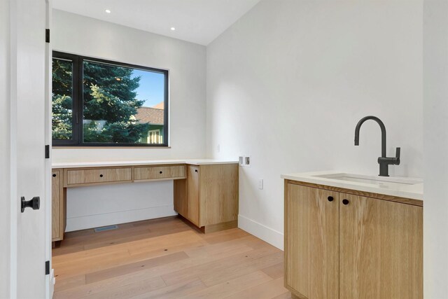 interior space with sink and hardwood / wood-style floors