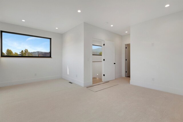 unfurnished room with light colored carpet