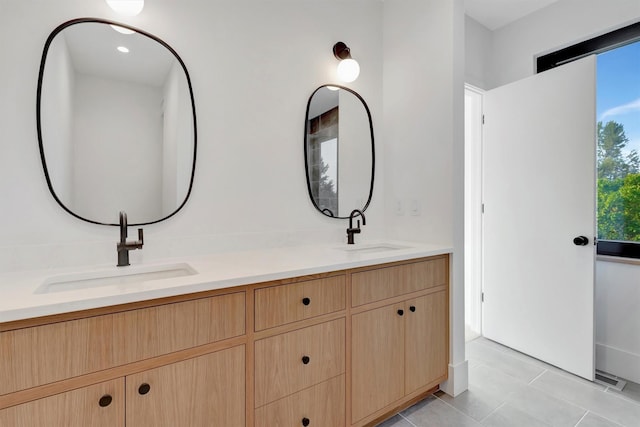 bathroom with tile patterned flooring and vanity