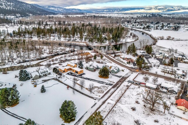 snowy aerial view with a mountain view