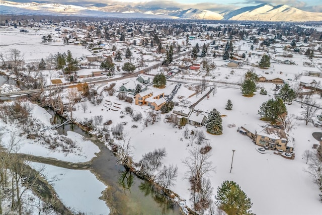 snowy aerial view with a mountain view